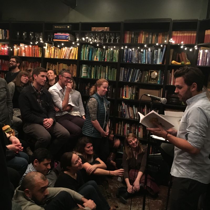 Zachary Reading Student Work at an Open Mic Night