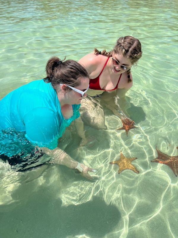 Catie & Her Sister Picking Up Starfish on Vacation