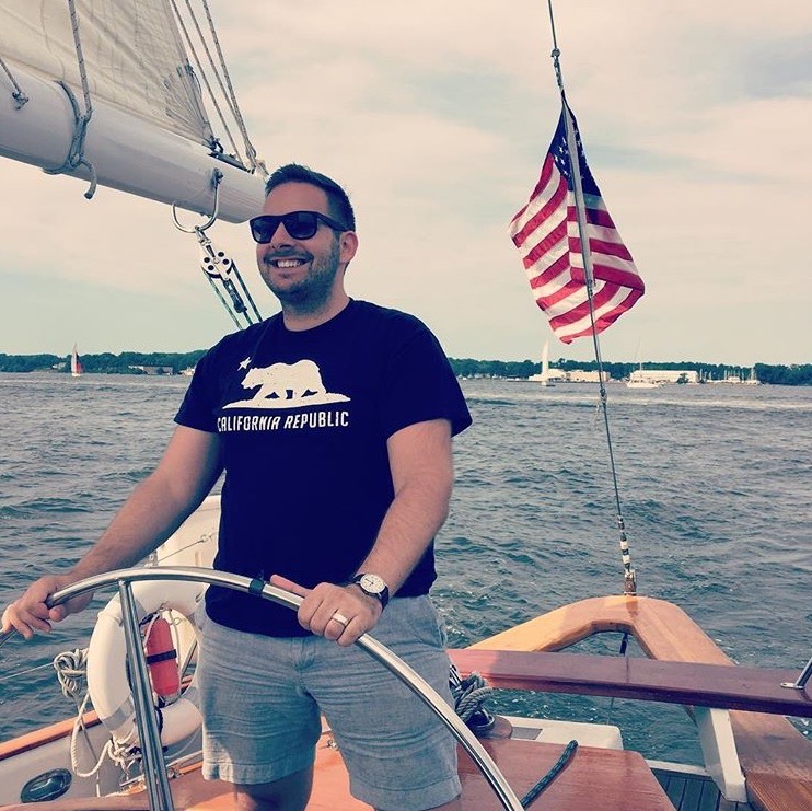 Captain Nick Taking a Spin at the Wheel During a Cruise on Chesapeake Bay